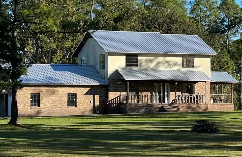 Same house with new light gray metal roof, after