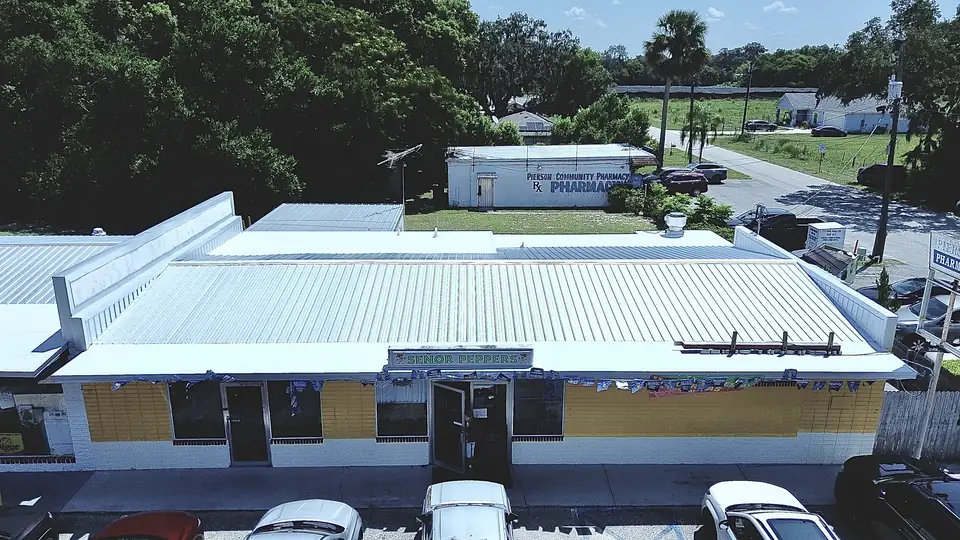 Commercial strip with new white metal roof